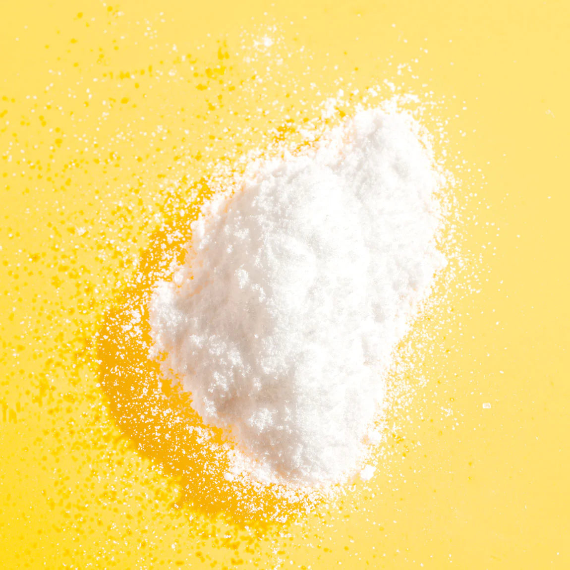 Vitamin c powder on yellow background