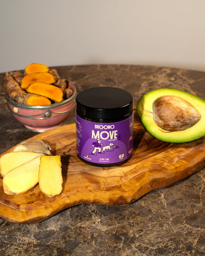 Broono Move jar on a wooden board with turmeric and an avocado.